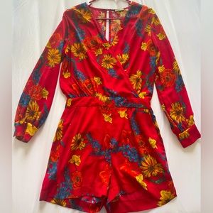 Red and flowered long sleeve jumpsuit perfect for spring.